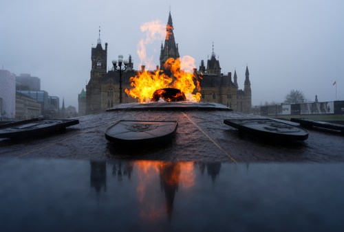 The West Block of Parliament Hill is pictured behind the Centennial Flame as a heavy fog hangs over downtown Ottawa on Thursday, April 16, 2026. THE CANADIAN PRESS/Sean Kilpatrick