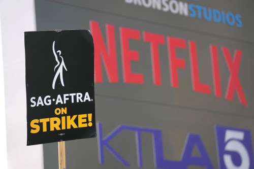 FILE - A picketer carries a sign on the picket line outside Netflix on Wednesday, Sept. 27, 2023, in Los Angeles. (AP Photo/Chris Pizzello, File)