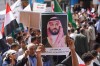 A Yemeni protester raises a poster of Saudi Crown Prince Mohammed bin Salman during a march to protest Iranian attacks on Saudi Arabia in Taiz, Yemen, Monday, March 30, 2026. (AP Photo/Abdulnasser Alseddik)