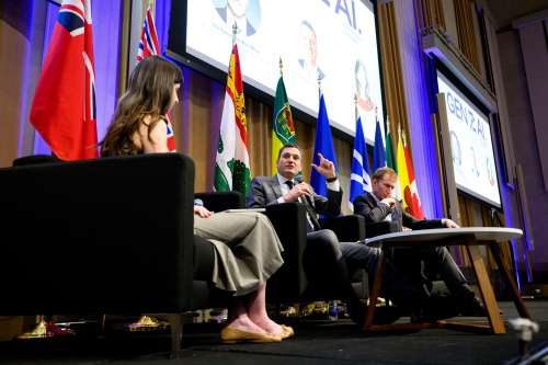 Evan Solomon, minister of artificial intelligence, centre, speaks during a Gen(Z)AI Plenary Convening fireside chat in Ottawa on Thursday, April 30, 2026. THE CANADIAN PRESS/Spencer Colby