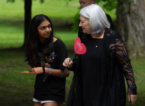 Governor General Mary Simon speaks with a student before they plant messages in a heart garden on the grounds of Rideau Hall on National Indigenous Peoples day, Friday, June 21, 2024 in Ottawa. THE CANADIAN PRESS/Adrian Wyld
