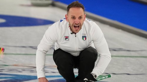 Italy's Joel Retornaz yells during the men's curling round robin session against Britain, at the 2026 Winter Olympics, in Cortina d'Ampezzo, Italy, Friday, Feb. 13, 2026. (AP Photo/Misper Apawu)