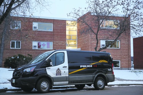 A Brandon police vehicle is parked in front of an apartment block on McDiarmid Drive on Nov. 3, 2023, after the body of 71-year-old Maureen Heymans was discovered inside one of the units. (Geena Mortfield/The Brandon Sun files)