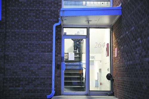 Police officers are seen in a stairwell in an apartment building on McDiarmid Drive on Nov. 3, 2023, after the body of Maureen Heymans was discovered inside one of the units. (Geena Mortfield/The Brandon Sun files)
