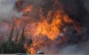 A giant fireball is seen as a wild fire rips through the forest 16 km south of Fort McMurray, Alta., on Highway 63 on May 7, 2016. THE CANADIAN PRESS/Jonathan Hayward
