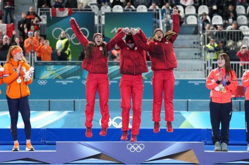 Canada's Ivanie Blondin, Isabelle Weidemann and Valerie Maltais celebrate on the podium after winning the gold medal in the final of the women's team pursuit speedskating race at the 2026 Winter Olympics, in Milan, Italy, Tuesday, Feb. 17, 2026. THE CANADIAN PRESS/Nathan Denette