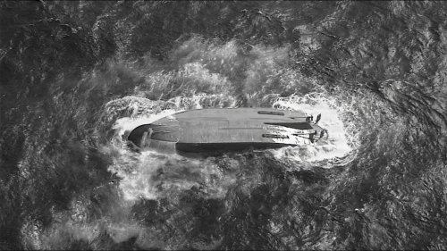 A U.S. Coast Guard HC-130 Hercules airplane crew assigned to Coast Guard Air Station Barbers Point flies over an overturned vessel offshore Saipan, Saturday, April 18, 2026, while searching for a missing vessel, the Mariana, that experienced an engine failure April 15. (U.S. Coast Guard/Air Station Barbers Point via AP)