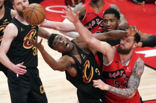 Cleveland Cavaliers' Thomas Bryant (3) and Toronto Raptors' Sandro Mamukelashvili (54) battle for the rebound during second half NBA playoff basketball action in Toronto on Friday, May 1, 2026. THE CANADIAN PRESS/Nathan Denette