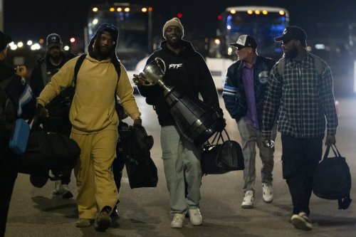 Toronto Argonauts wide receiver DaVaris Daniels carries the Grey Cup while walking alongside his teammates as they arrive at Toronto Pearson International Airport in Mississauga, Ont., Monday, Nov. 18, 2024. The Argonauts defeated the Winnipeg Blue Bombers on Sunday to win the cup. THE CANADIAN PRESS/Arlyn McAdorey