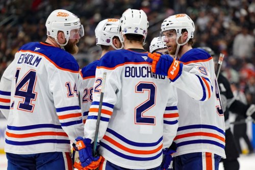 Edmonton Oilers centre Connor McDavid, right, speaks with defenceman Mattias Ekholm, left, and defenceman Evan Bouchard (2) during the third period of an NHL hockey game against the Los Angeles Kings, Saturday, April 11, 2026, in Los Angeles. (AP Photo/Ryan Sun)