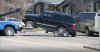 A vehicle where two children were found dead is being towed away as police watch the scene in Calgary on Thursday April 30, 2026. The children's father accused in their death remains in custody. THE CANADIAN PRESS/Dayne Patterson