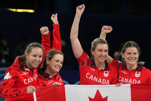 Canada's Rachel Homan, Tracy Fleury, Sarah Wilkes and Emma Miskew celebrate winning their women's curling bronze medal match against the United States at the 2026 Winter Olympics in Cortina d'Ampezzo, Italy on Feb. 21, 2026. (AP Photo/Fatima Shbair)