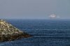 Cargo ships are seen at sea near the Strait of Hormuz, as viewed from a rocky shoreline near Khor Fakkan, United Arab Emirates, Friday, May 1, 2026. (AP Photo/Fatima Shbair)