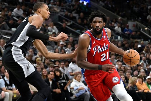 Philadelphia 76ers center Joel Embiid (21) drives against San Antonio Spurs center Victor Wembanyama, left, during the first half of an NBA basketball game, Monday, April 6, 2026, in San Antonio. (AP Photo/Darren Abate)