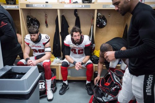 Ottawa Redblacks' Marco Dubois, left, and Jean-Christophe Beaulieu sit in the dressing room after losing to the Calgary Stampeders during the 106th Grey Cup in Edmonton, Alta. Sunday, Nov. 25, 2018. THE CANADIAN PRESS/Jason Franson