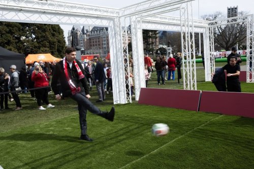 Premier David Eby takes a shot on net at one of the interactive centres on the grounds of the legislature during the FIFA World Cup 2026 countdown celebration event in Victoria, B.C., on Tuesday, March 31, 2026. THE CANADIAN PRESS/Chad Hipolito