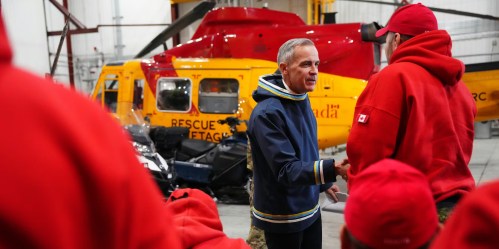Prime Minister Mark Carney meets with members of the Canadian Rangers in Iqaluit, Nunavut, in 2025. There are roughly 5,000 Canadian Rangers, part of the Canadian Armed Forces, who provide a paramilitary presence in the North and in other remote areas. (The Canadian Press)