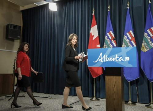 Alberta Premier Danielle Smith, right, and Hospitals Minister Adriana LaGrange enter to speak at a news conference in Calgary on Wednesday, Feb. 19, 2025. THE CANADIAN PRESS/Jeff McIntosh