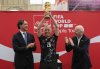 Prime Minister Mark Carney raises the FIFA World Cup trophy during a trophy tour event at Lansdowne Park's Aberdeen Pavilion, as FIFA president Gianni Infantino, right, and Italian soccer legend Alessandro Nesta, left, look on in Ottawa on Sunday, May 24, 2026. THE CANADIAN PRESS/Justin Tang