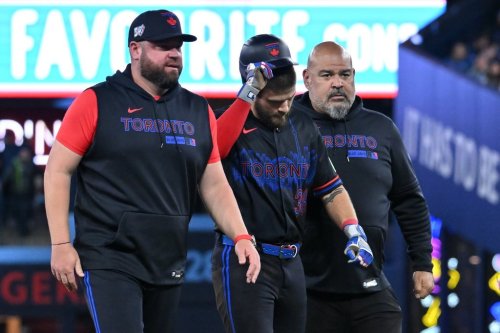 Toronto Blue Jays' Nathan Lukes, centre, leaves the game after getting injured sliding into second base against the Cleveland Guardians in first inning MLB baseball game action in Toronto on Friday, April 24, 2026. THE CANADIAN PRESS/Jon Blacker