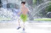 Six-year-old Moses Hunter cools himself off in the splash pad at Provencher Park in Winnipeg on Wednesday afternoon. (Ruth Bonneville/Winnipeg Free Press)