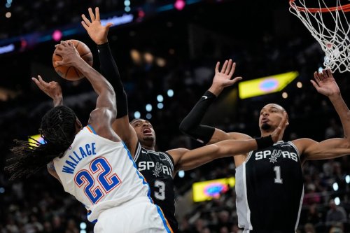 Oklahoma City Thunder guard Cason Wallace (22) shoots against San Antonio Spurs forward Keldon Johnson (3) in the second half of Game 6 in the Western Conference finals NBA basketball playoffs series, Thursday, May 28, 2026, in San Antonio. (AP Photo/David J. Phillip)