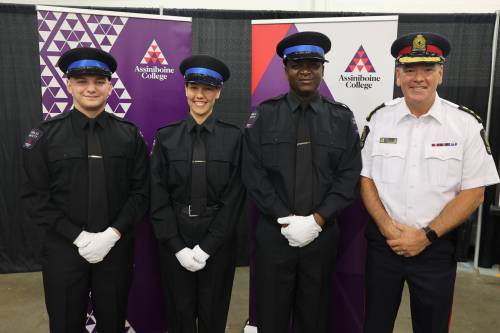 Assiniboine College public safety program graduates Mason Vinthers (from left), Michelle Omand and Osahon Ebose are joined by Brandon Police Service Chief Tyler Bates after the graduation ceremony at the college&rsquo;s Victoria East Campus on Friday morning. (Abiola Odutola/The Brandon Sun)