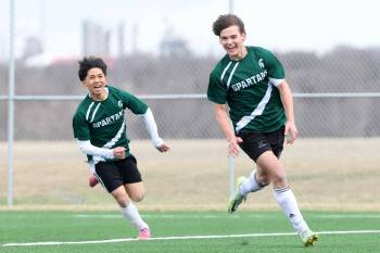 Emytt Pearce (21) of the Neelin Spartans (right) celebrates a goal during varsity boys soccer against the Crocus Plainsmen at Cougars Field in Brandon on Monday afternoon. (Photos by Tim Smith/The Brandon Sun)