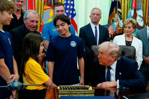 U.S. President Donald Trump speaks with children before signing a proclamation in the Oval Office at the White House on Tuesday. (The Associated Press)