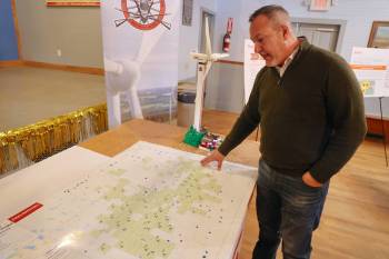 Manitoba Métis Federation senior economic adviser Lorne Pelletier gestures at a preliminary map where wind turbines are proposed around Polonia during a recent open house in the community. The green squares represent properties where the owner has made an early agreement to possibly host a wind turbine on their land. The locations are subject to change over time. (Connor McDowell/The Brandon Sun files)