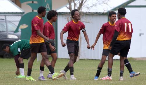 Crocus Plainsmen Ben Ibitoye, centre, celebrates after scoring the game-winning goal of the city boys soccer semifinal on Wednesday. (Thomas Friesen/The Brandon Sun)