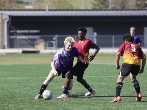 Vincent Massey Vikings winger Ben Sveistrup (21) battles for a ball during the first half of the Brandon High School Soccer League final against the Crocus Plainsmen in the final at Cougars Field on Monday afternoon. (Massimo De Luca-Taronno/The Brandon Sun)