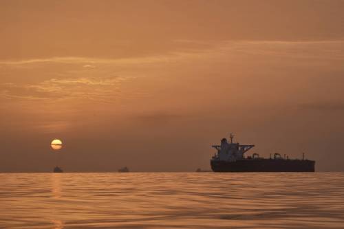The sun rises behind tankers anchored in the Strait of Hormuz off the coast of Qeshm Island, Iran, last month. (The Associated Press)