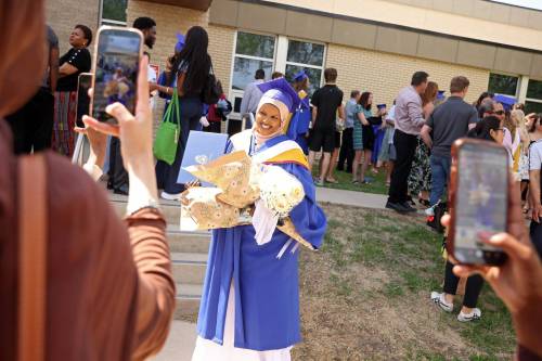 Friends take videos and photos of bachelor of nursing graduate Fahimo Ismail after Brandon University&rsquo;s 2026 convocation for the Faculty of Health Studies at the BU Healthy Living Centre on Friday. (Photos by Tim Smith/The Brandon Sun)