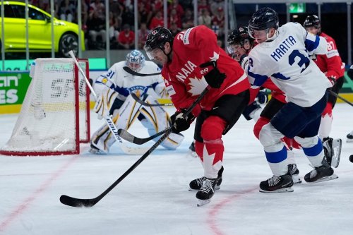 Canada's Dylan Cozens (24) challenges with Finland's Olli Maatta (3) during the 2026 IIHF Men's Ice Hockey World Championship semifinal match between Canada and Finland, in Zurich, Switzerland, Saturday, May 30, 2026, (AP Photo/Darko Bandic)
