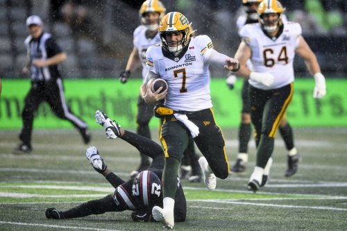 Edmonton Elks' quarterback Cody Fajardo (7) tries to evade a tackled by Ottawa Redblacks' defensive lineman Habakkuk Baldonado (95) during first half regular season CFL action in Ottawa, on Saturday, June 6, 2026. THE CANADIAN PRESS/Spencer Colby