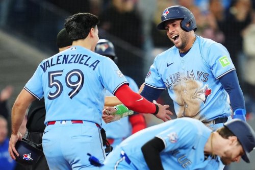 Toronto Blue Jays' Brandon Valenzuela (59) and George Springer (right) celebrate after scoring against the Tampa Bay Rays during seventh inning MLB baseball action in Toronto on Tuesday, May 12, 2026. THE CANADIAN PRESS/Frank Gunn