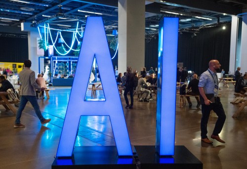 People walk past an AI sign at the All In artificial intelligence conference, Thursday, Sept. 28, 2023, in Montreal. THE CANADIAN PRESS/Ryan Remiorz