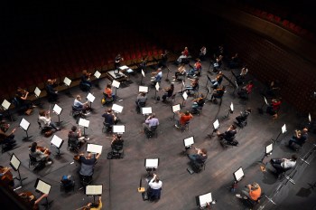 FILE - Chief Conductor Elim Chan, center top, conducts the Antwerp Symphony Orchestra through a rehearsal at the Queen Elisabeth Hall in Antwerp, Belgium, July 1, 2020. (AP Photo/Virginia Mayo, File)