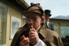 Philip Porter, playing Sherlock Holmes, looking through a magnifying glass during an event recreating the fateful confrontation between Sherlock Holmes and Professor Moriarty by the members of the Sherlock Holmes Society of London, at the Reichenbach Falls, Switzerland, May 3, 2026. (AP Photo/Niccolo Lupone, Pool)