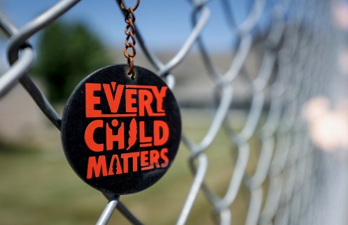 A key chain dangles from a fence as part of a memorial outside the former Kamloops Indian Residential School in Kamloops, B.C., Thursday, June 1, 2023. THE CANADIAN PRESS/Jeff McIntosh