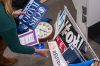 FILE - Washington Post reporter Tara Copp saves the name plaques from various news organizations as she and members of the media pack up their belongings in the press area in the Pentagon, Oct. 15, 2025 in Washington. (AP Photo/Kevin Wolf, File)
