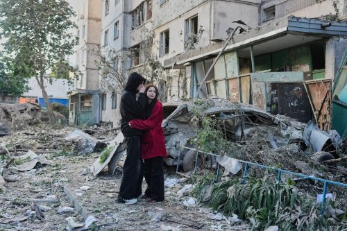People react as they look at the site of Russian missile strike that hit a residential building in Kyiv, Ukraine, Tuesday, June 2, 2026. (AP Photo/Efrem Lukatsky)