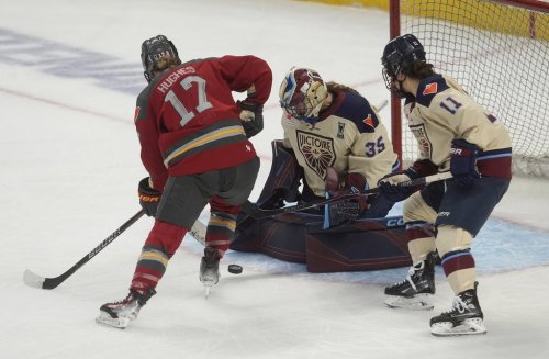 Montreal Victoire forward Abby Roque (11) looks on as Ottawa Charge forward Gabbie Hughes (17) pressures goalie Ann-Renee Desbiens (35) during first period PWHL Walter Cup final hockey action in Ottawa, Wednesday, May 20, 2026. THE CANADIAN PRESS/Adrian Wyld