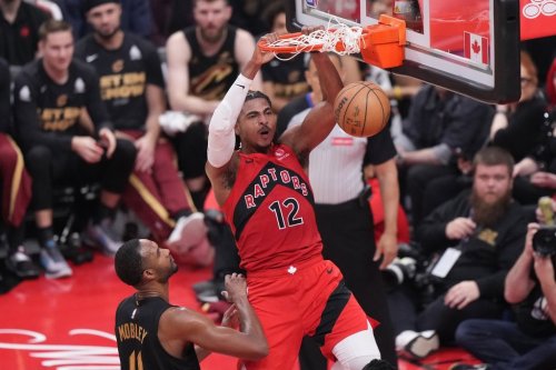 Toronto Raptors forward Collin Murray-Boyles (12) dunks as Cleveland Cavaliers centre Evan Mobley (4) looks on during first half NBA playoff basketball action in Toronto on Sunday, April 26, 2026. THE CANADIAN PRESS/Nathan Denette