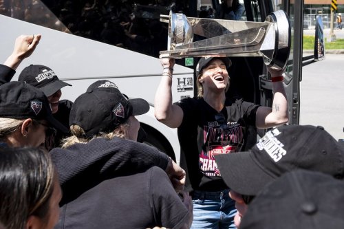 Montreal Victoire's Marie-Philip Poulin hoists the Walter Cup after arriving in Montreal following winning the franchise's first championship, on Thursday, May 21, 2026. THE CANADIAN PRESS/Christopher Katsarov