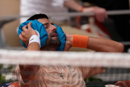 Novak Djokovic of Serbia cools himself during a break of the third round men's singles tennis match against Joao Fonseca of Brazil at the French Open tennis tournament in Paris, Friday, May 29, 2026. (AP Photo/Christophe Ena)