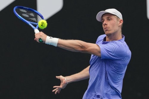 Denis Shapovalov of Canada plays a forehand return to Bu Yunchaokete of China during their first round match at the Australian Open tennis championship in Melbourne, Australia, Monday, Jan. 19, 2026. (AP Photo/Aaron Favila)