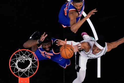 San Antonio Spurs forward Keldon Johnson, right, and New York Knicks center Mitchell Robinson (23) battle for the ball during the second half of Game 2 of the NBA Finals basketball series, Friday, June 5, 2026, in San Antonio. (AP Photo/Eric Gay)