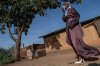 A Muslim woman walks towards the prayer grounds at Sayo Muhamed School to perform Eid al-Adha prayers amid an Ebola outbreak in Bunia, Congo, Wednesday, May 27, 2026. (AP Photo/Moses Sawasawa)